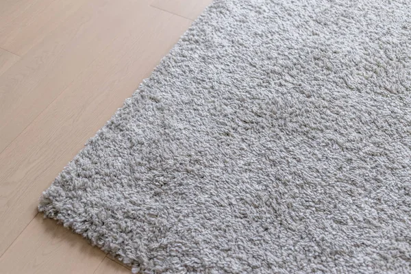 Grey carpet on the wooden floor