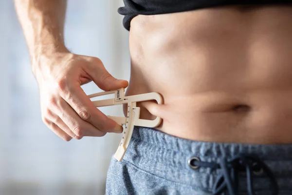 Close Athlete Person Measuring His Body Fat Caliper Gym — Stock Photo, Image