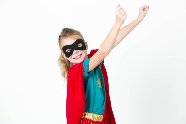 beautiful blond supergirl with black mask and red cape posing in front of white background clipart