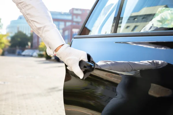 Close-up Of Male Valet Opening Car Door