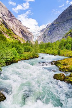 Landscape with river near Briksdal or Briksdalsbreen glacier in Olden, Norway with green mountain. Norway nature and travel background. Summer in Norway, glacier Briksdalsbreen clipart