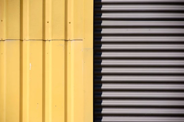 The detail of a facade with two types of corrugated iron, round and angular...