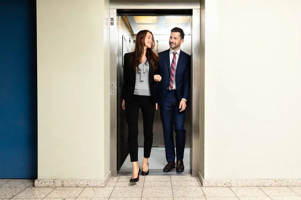 Happy Young Couple Coming Out Elevator — Stock Photo, Image