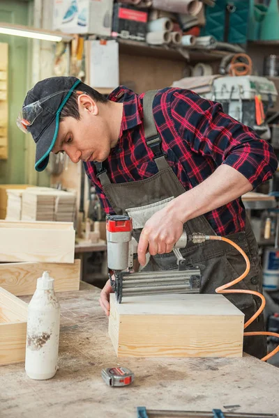 stock image Worker making the wood box. Profession, carpentry and woodwork concept.