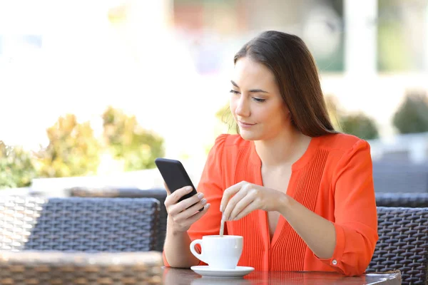 Woman Stirring Coffee Checking Smart Phone Content Sitting Bar Terrace — Stock Photo, Image