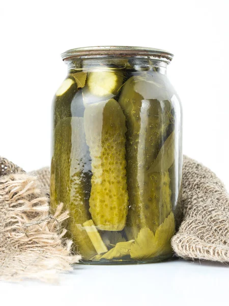 Pickled cucumbers isolated. Pickles in glass jar isolated on white background. Salted cucumber in jar isolated