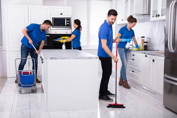Groep Jonge Janitors Uniforme Schoonmaak Keuken Thuis — Stockfoto