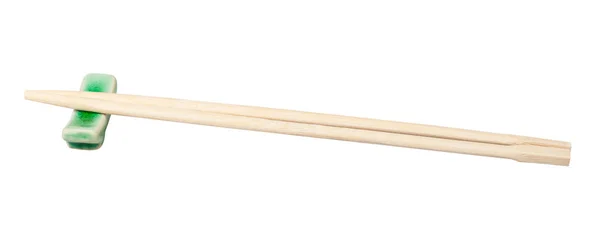 白い背景に孤立した箸置きで出される使い捨ての木箸の側面図 — ストック写真