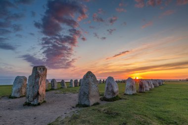 Ales Stenar - An ancient megalithic stone ship monument in Southern Sweden photographed at sunset. clipart