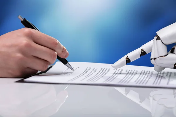 Robotic Hand Assisting Person Filling Form Reflective Desk — Stock Photo, Image