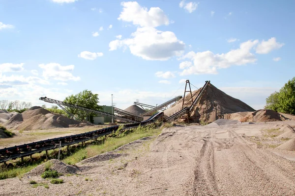 A string of transport belting in a gravel pit for transporting gravel and sand over long distances.