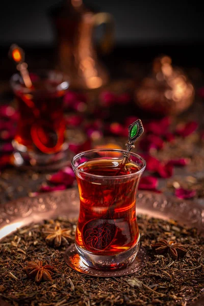 Turkish tea served in the typical manner, in a glass on a small saucer