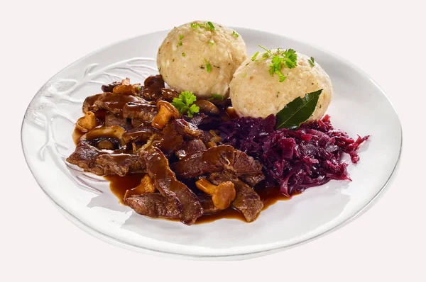 Swiss ragout from Zurich with strips of braised meat in a rich gravy with small mushrooms served with dumplings and shredded red cabbage on a generic plate isolated on white