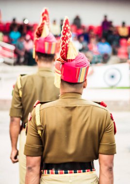 Portrait of an unrecognizable indian policeman standing in a row. Rear view. clipart