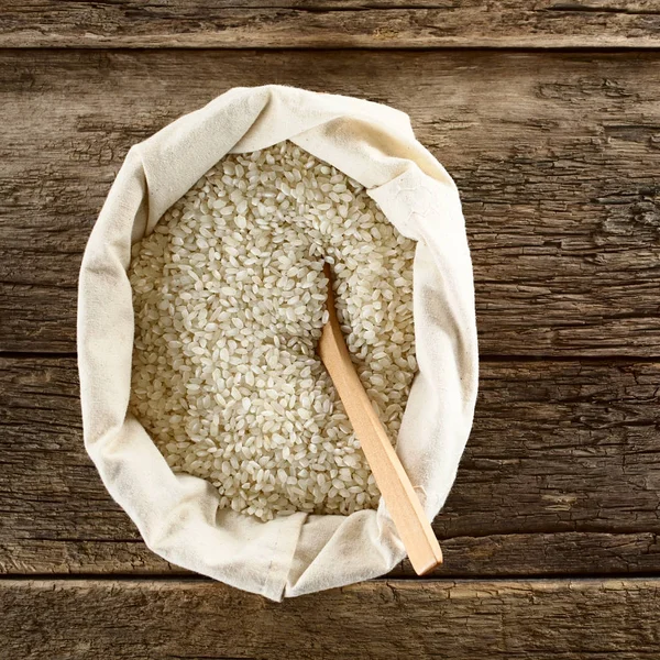 Ακατέργαστο Ριζότο Κοντό Ρύζι Σακούλα Ξύλινη Κουτάλα Φωτογραφημένο Πάνω Στο — Φωτογραφία Αρχείου