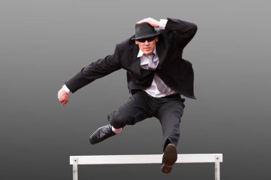 businessman jumps over hurdle clipart