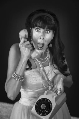 Shocked retro-styled woman holding telephone over maroon background clipart