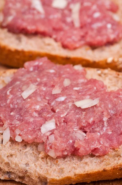 close up of a bun with onion mett