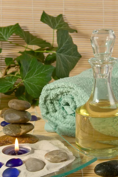 Bottle Massage Oil Burning Scented Candle Bath Towel Stones — Stock Photo, Image