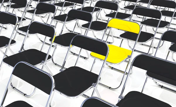 a yellow folding chair in the crowd