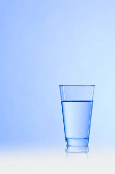 Water Glass Blue Background — Stok fotoğraf