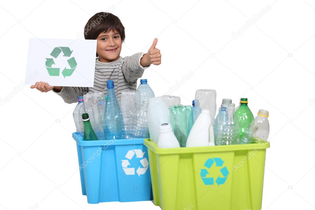 Little boy recycling at the daytime