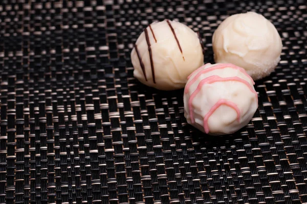 white truffles from chocolate on a dark background