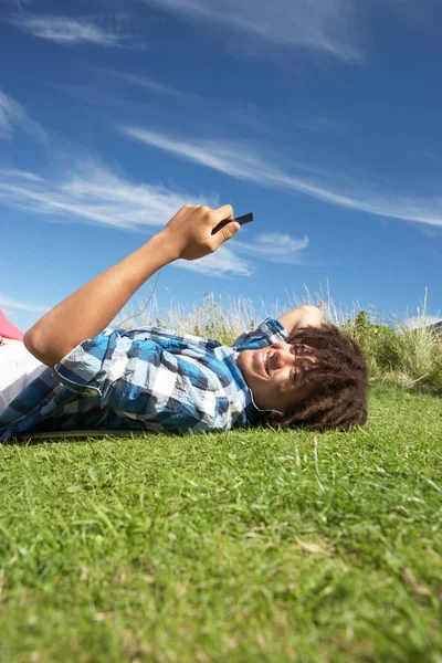 Teenage Boy Lying Grass Phone — Stock Photo, Image