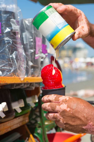 Fruit and ice cream vendor in action at Bocagrande Beach, Cartegena, Columbia.