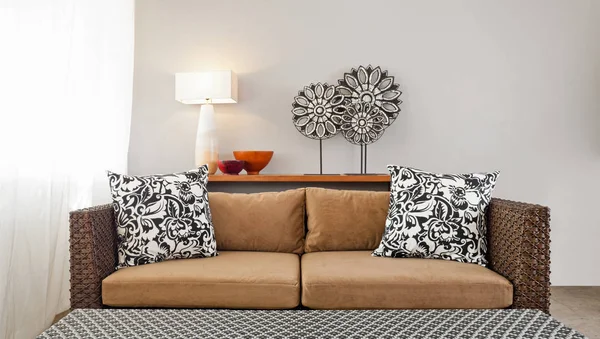 Beige brown sofa in luxurious interior setting.