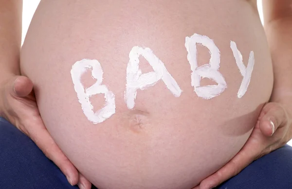 裸の腹を持つ妊婦と赤ちゃんという言葉 — ストック写真