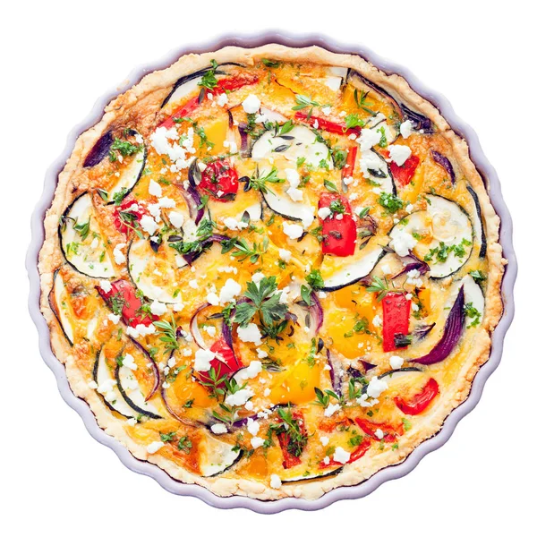 Overhead view of a delicious savory tart with clipping path in a decorative fluted pie dish with eggplant, cheese, egg, herbs and peppers for a tasty vegetarian meal