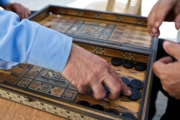 this photo was taken in byblos (lebanon) and shows two backgammon players. the aim was to represent the hand,despite movement,without blurring. i would be happy about numerous comments,hints and reviews.