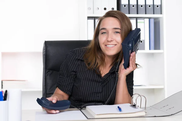 Una Joven Sonriente Mujer Sosteniendo Teléfono Oído Mientras Está Sentada — Foto de Stock