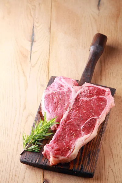 Uncooked Tender Lean Porterhouse Steak Sprig Fresh Aromatic Rosemary Seasoning — Stock Photo, Image