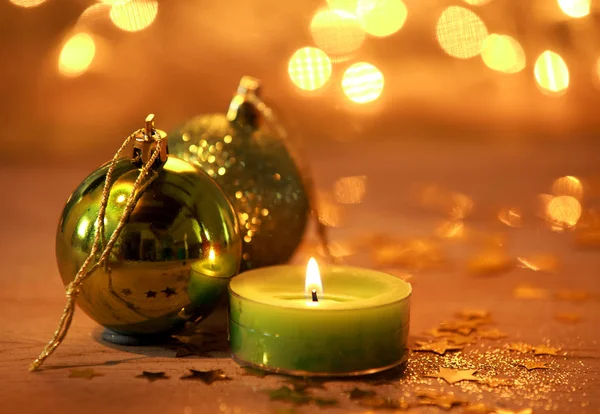 Warm Glowing Christmas Decoration Background Burning Green Candle Baubles Surrounded — kuvapankkivalokuva