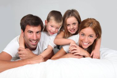 Family portrait laying in bed clipart