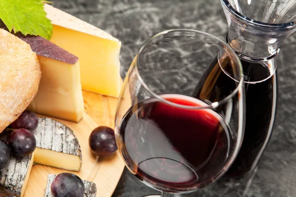 red wine with cheese plate grapes and bread