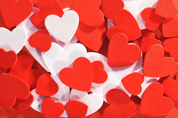 Many Small Red White Wood Hearts Red Background — Stock Photo, Image