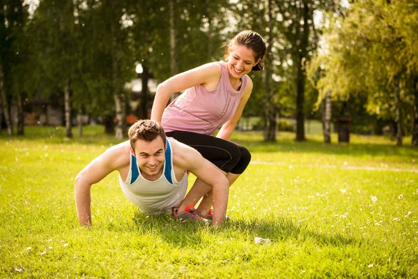 Sport Man Making Push Ups While Woman Sitting Him Weight Stock Picture