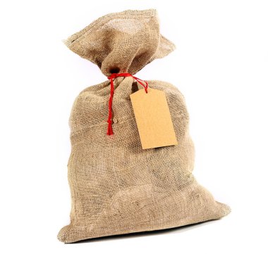 Rustic burlap sack tied with red string with a blank gift tag for your Christmas or seasonal greeting over white clipart