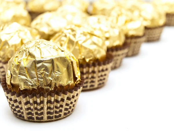 Rows Candies Gold Paper White Background Stock Picture