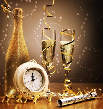 Elegant gold New Year still life with a clock counting down to midnight in front of a bottle and flutes of sparkling champagne with golden streamers and a bokeh of effervescent bubbles clipart