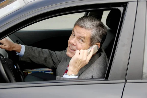 businessman in car phone with his cell phone