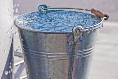 metal bucket with water droplets clipart