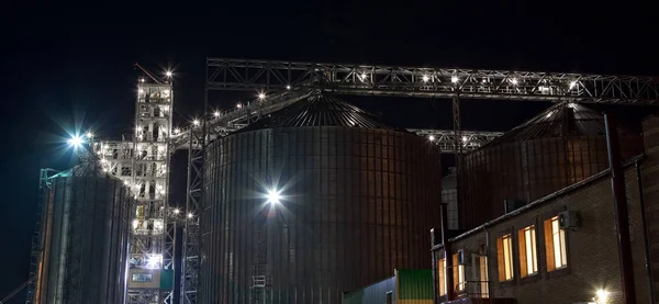 Towers of grain drying enterprise. metal grain facility with silos