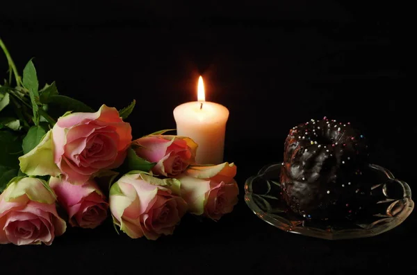 still life with roses,candle and cake
