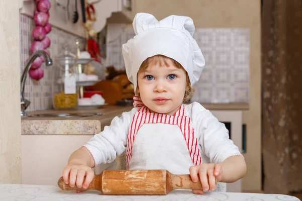Das Kleine Mädchen Schürze Und Kochmütze Mit Nudelholz Sitzt Esstisch — Stockfoto