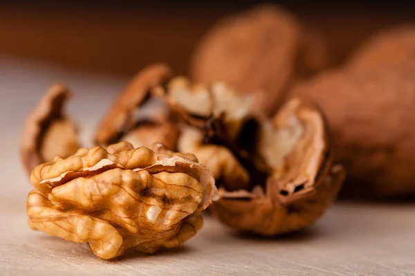 stock image walnuts on a board,a nut is opened.