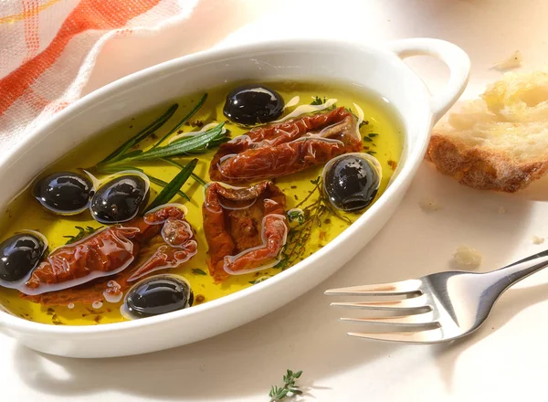 dry tomatoes and olives in olive oil